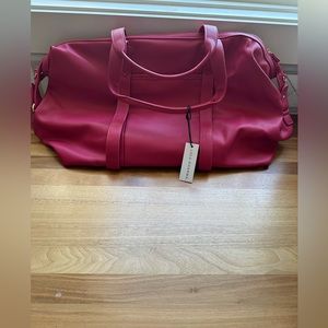 Lulu Dharma NYT pink embossed tote bag.